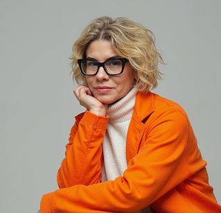 Minimalist blank book cover held in a bright room with flowers in the background.